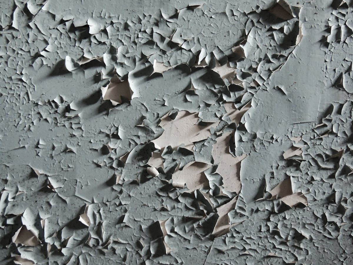Peeling and flaking coating showing classic epoxy floor failure from poor prep work